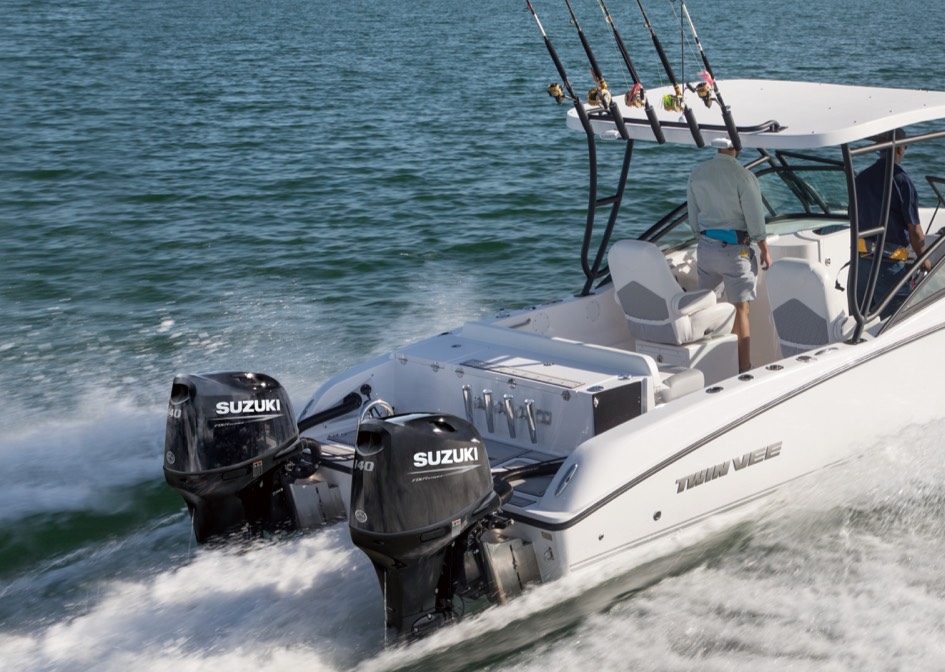 close-up, angled view of a powerboat in motion, highlighting its dual outboard motors and the wake it's creating