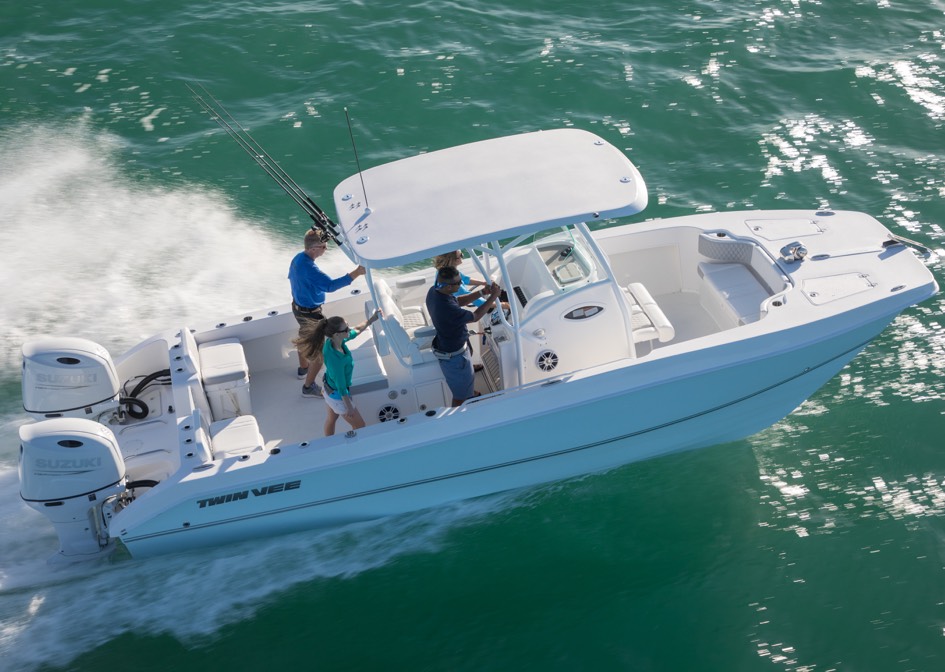 white small boat anchored with two white suzuki engine gliding in a shallow water