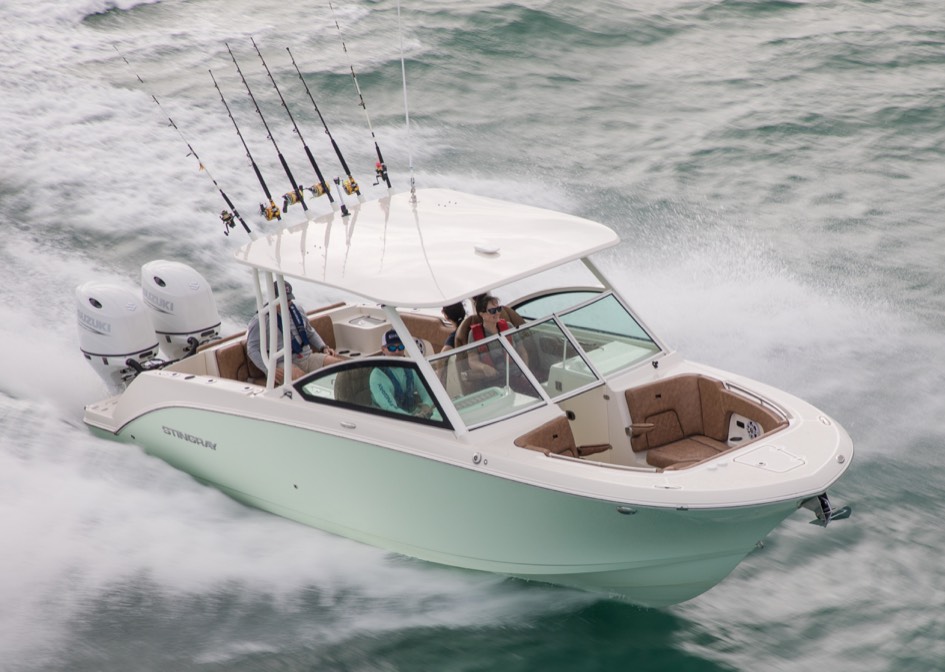 luxurious dual console fishing boat cruising through the water at high speed